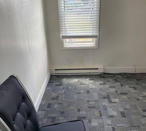 Bedroom 2 is currently furnished with a twin bed, desk and light.