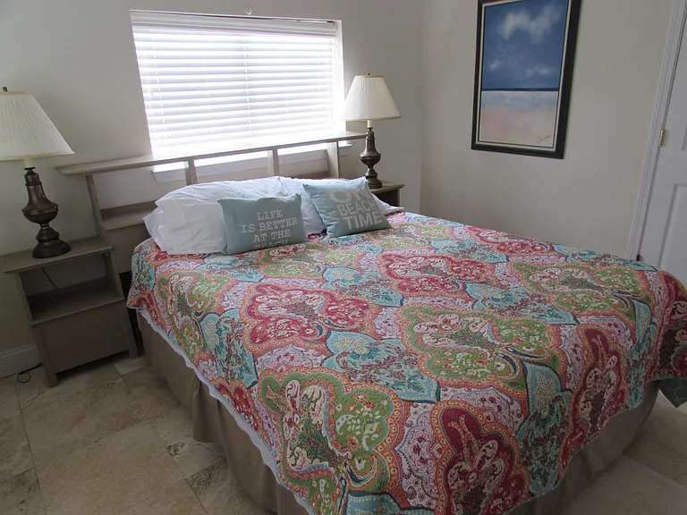Master bedroom (queen-sized bed) with chest-of-drawers and ample closet space.