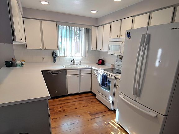 Kitchen with dishwasher, microwave, electric glass top oven, refrigerator