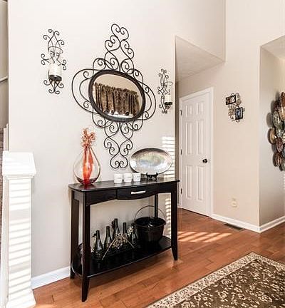 Dramatic 2 story entry flooded with sunlight and hardwood floors