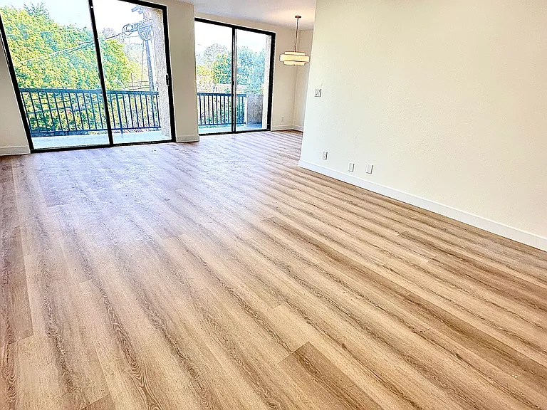 Unit #302 massive living room with stunning brand-new luxury vinyl flooring and recessed can lighting! Top Floor gorgeous Brentwood tree views and Bel Air/Brentwood Mountain Views!