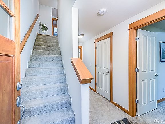 Entryway with office/bedroom and attached garage on left