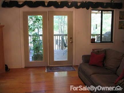 Den/Eati-in Kitchen
						:
						Wood floors with access to large partially covered deck.