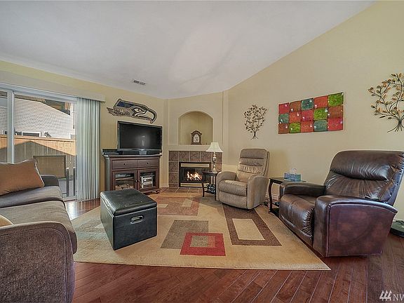 Large family room with slider to backyard patio- vaulted ceilings, gas fireplace, hardwood floors & great entertaining. 