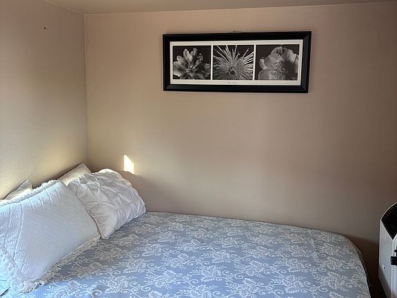 Full size bed in bedroom.