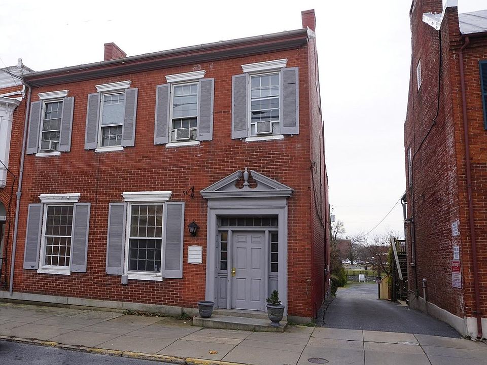 Front of property. The two lower windows look into the apartment. The alley goes back to the parking area, and the Carroll Creek promenade is also visible.