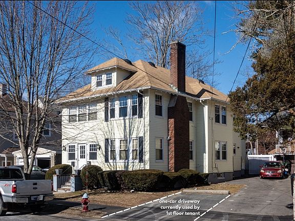 Photo of the outside of the house & paved parking spot (1) on the right side of the house for tenants