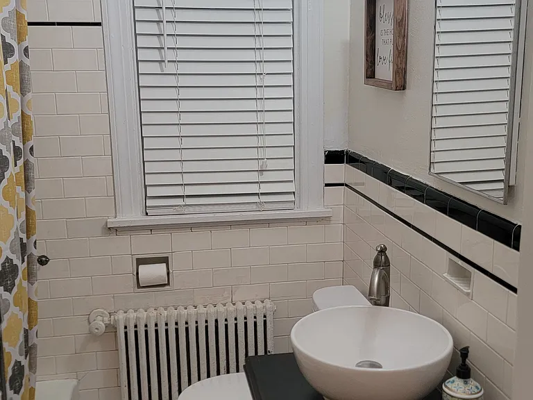 Downstairs bath between two bedrooms.