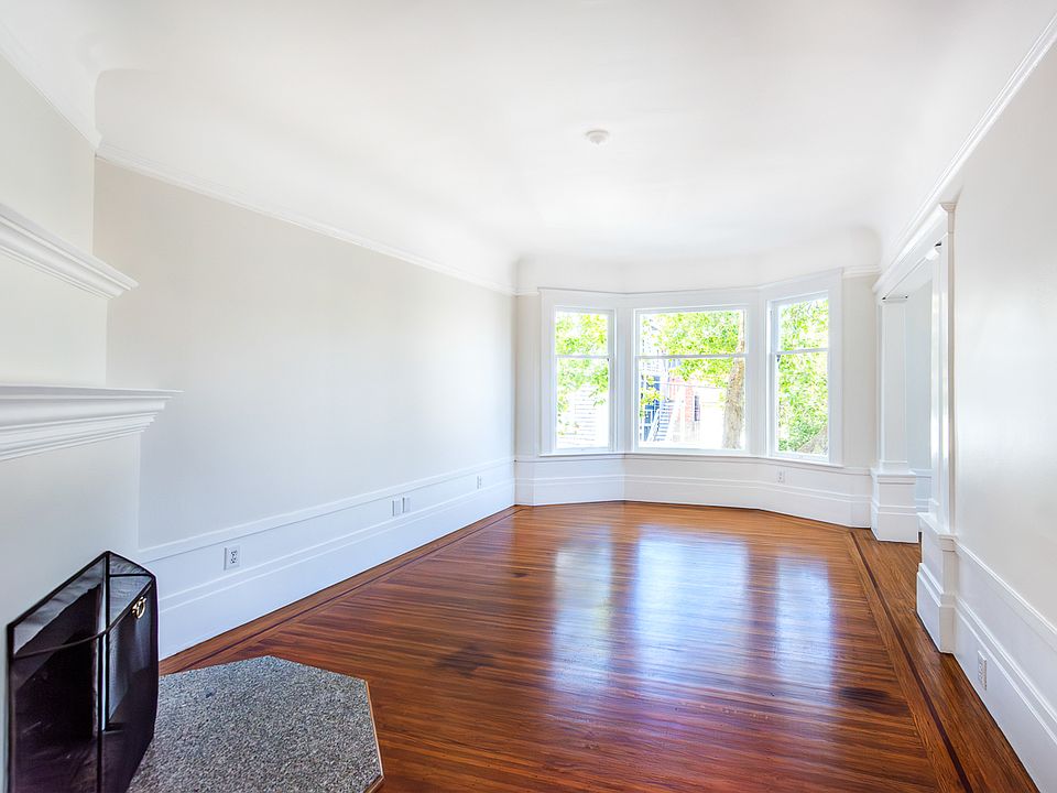 Living room with bay windows facing Henry Street (view from dining room)