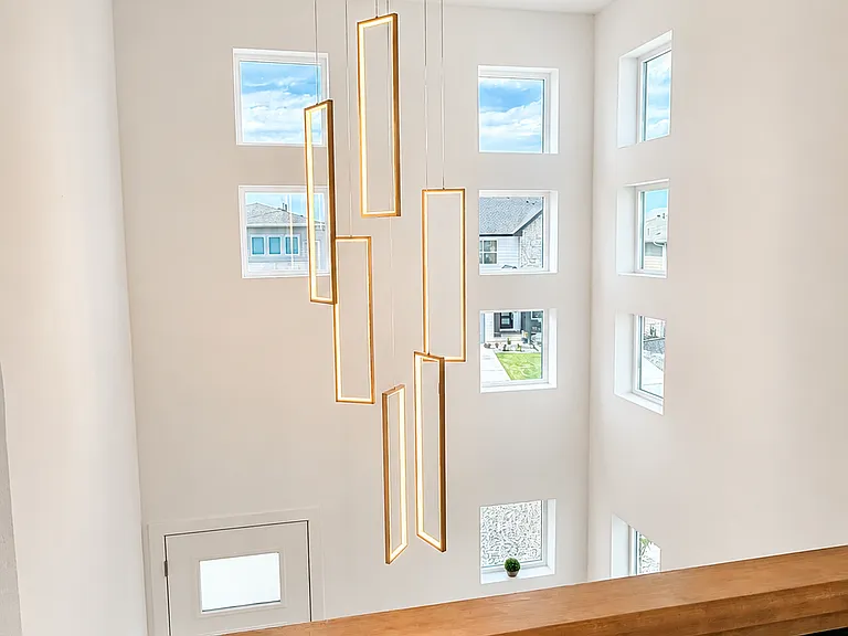 Vaulted Ceiling Foyer with Modern Chandelier and tons of Natural Light