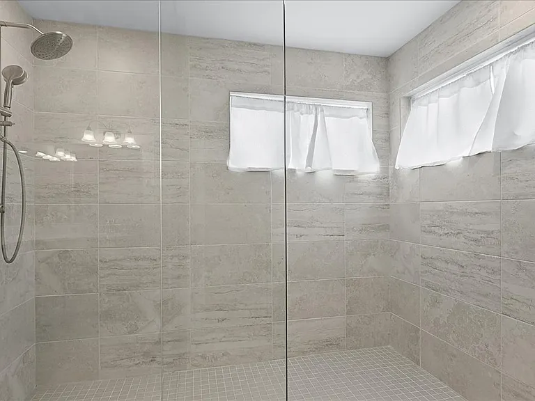 Primary bathroom with dual sinks, granite countertops, walk in shower, and walk in closet