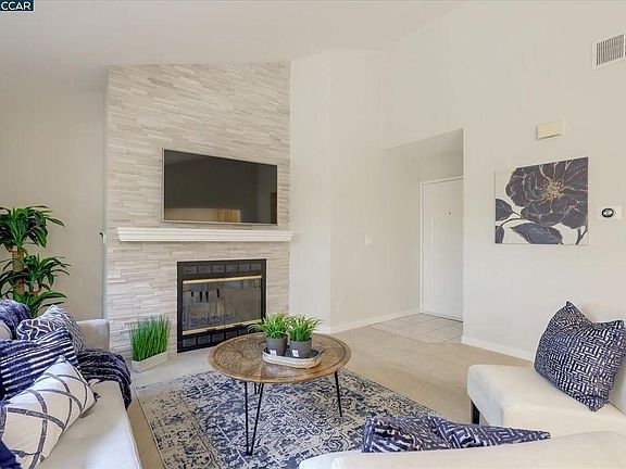 leaving area with fireplace and wall TV mounting