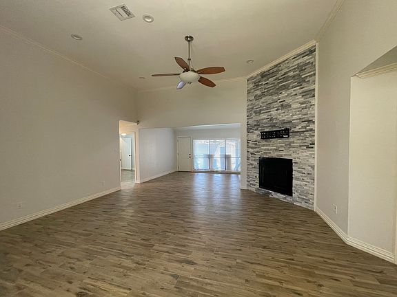 Living room with den leading to backyard