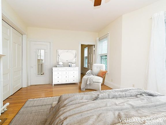 Bedroom view to closet or office. Sliding doors to the left open to the living room. Virtually staged.