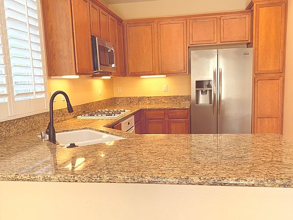 Open concept kitchen, w/ granite counter, plenty of storage and includes gas stove, refrigerator, new microwave and dishwasher