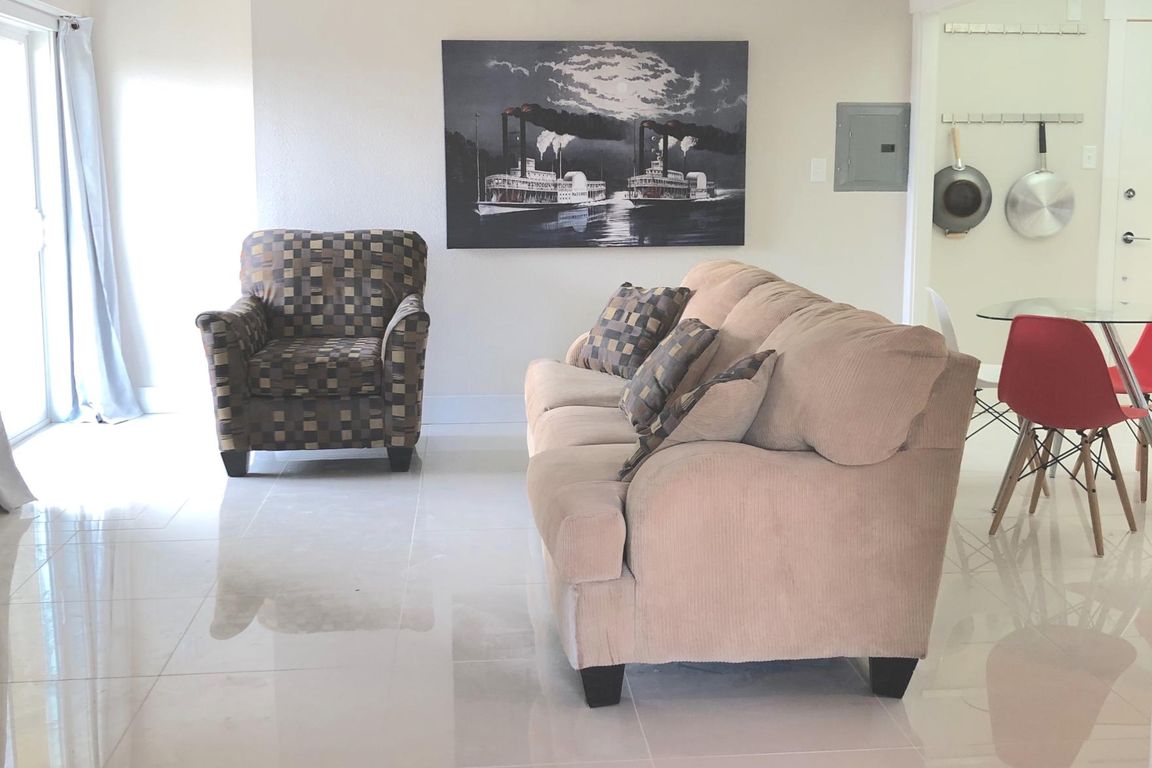 The Pat: 1BD / 1BA. Great room. Walk-out balcony. Shown with transitional decor.