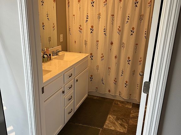 Primary bedroom ensuite with dual vanities and large walk-in closet