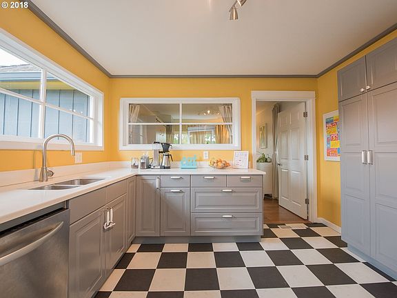 Kitchen with ample storage, fridge, dishwasher, microwave, oven, garbage disposal.