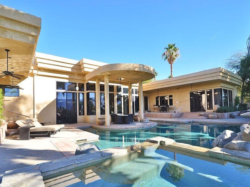 Rear of home with resort-style pool & spa.