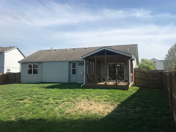 back of house with deck