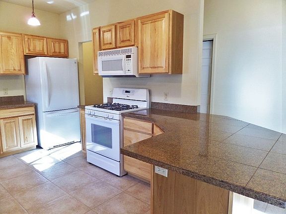 Kitchen
						:
						Refrigerator, microwave, and gas stove.