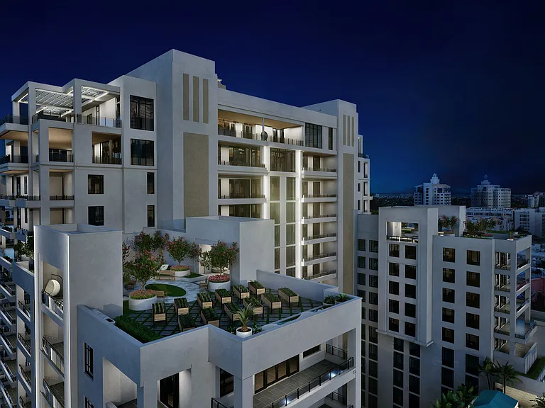 Aerial nighttime view of Regency Parc's Resort Deck, showcasing pool and cabanas.
