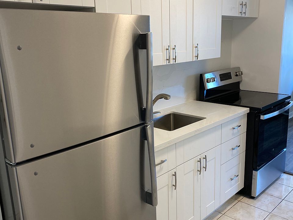 Newly renovated kitchen with quartz countertop and stainless steel appliances.
