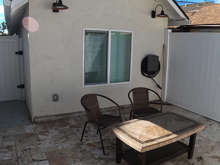 private fenced backyard with chairs and table