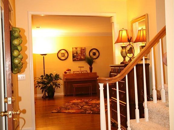Entryway with updated lighting & hardwood floors