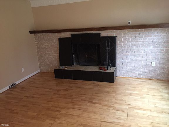 Natural, wood burning fireplace in living room