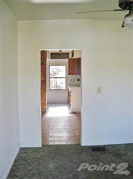 walk in the front door into the living room and you can see the cute galley eat-in kitchen