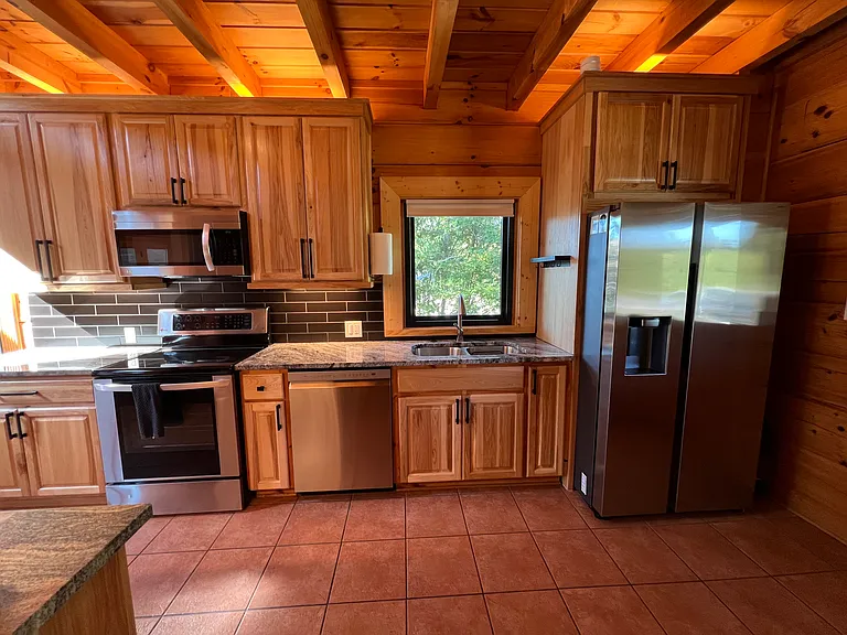 Kitchen: brand new stainless steel refrigerator. Also includes: oven, microwave, dishwasher, and sink with garbage disposal.
