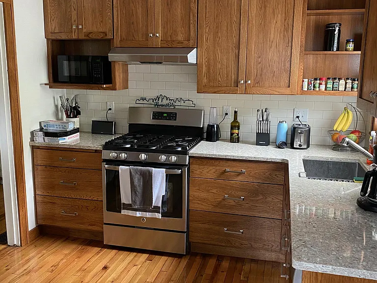 Gas Stove, Quartz countertop, ceramic backsplash, Kohler sink.