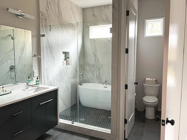 Bathroom attached to first master (currently being used as an office) Has double sinks and a soaking tub.