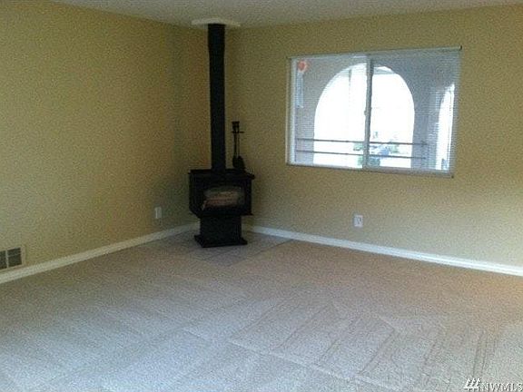 Living room with wood burning fireplace