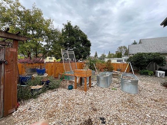 Carefree yard with lots of planters for growing food or flowers.