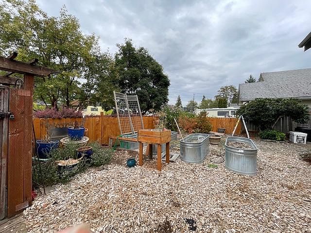 Carefree yard with lots of planters for growing food or flowers.