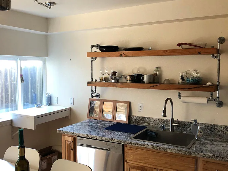Large stainless steel kitchen sink with disposal.