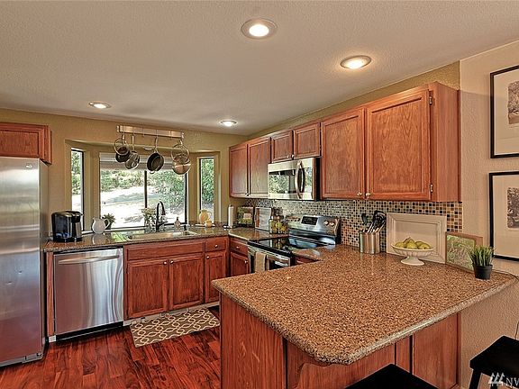Light bright kitchen with granite counters and updated SS appliances.