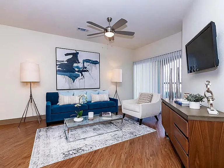 Living area boasts luxury vinyl plank flooring and ceiling fans