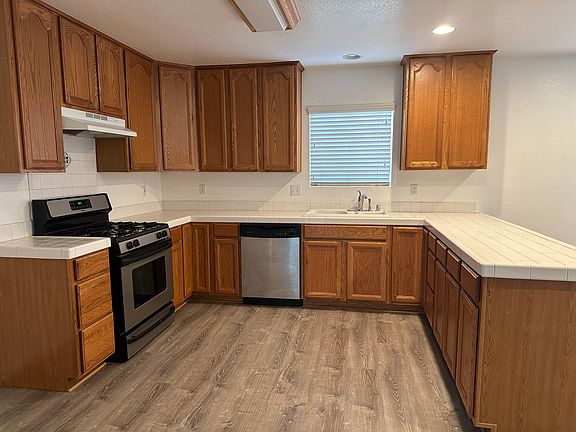 Kitchen with gas range, dishwasher and space for 3' fridge with ice maker hook-up. 12' x 11'