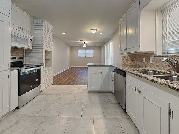 Spacious kitchen with white ca