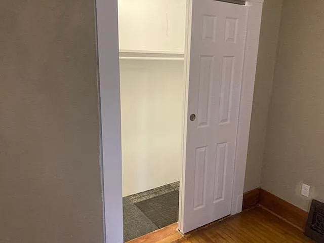 Closet in the master bedroom. Master bedroom has wood flooring. One window in the room.