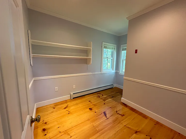 Room off entryway (with stairs to basement)