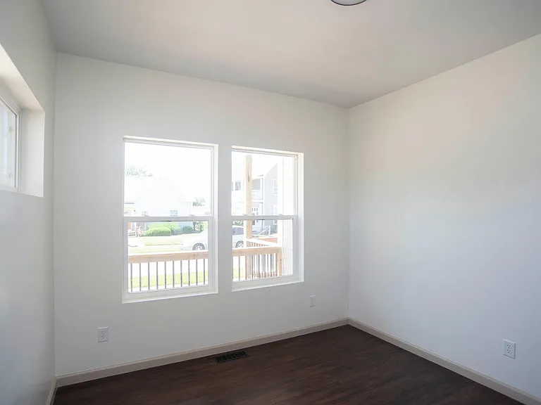Downstairs bedroom or study overlooking front patio with south facing windows