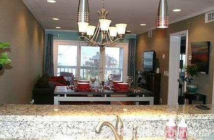 View Into Living Room from Kitchen
						:
						Open floor plan with view from kitchen. Granite countertops, pendant lights.