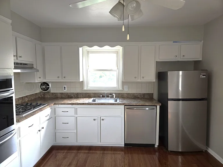 Freshly painted kitchen with ceiling fan.