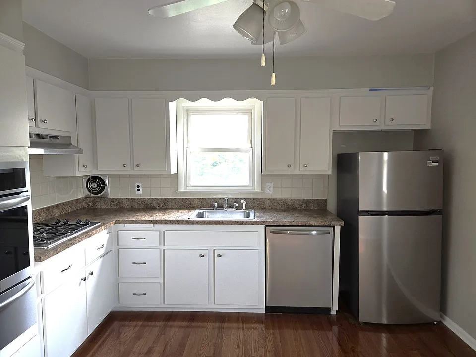 Freshly painted kitchen with ceiling fan.