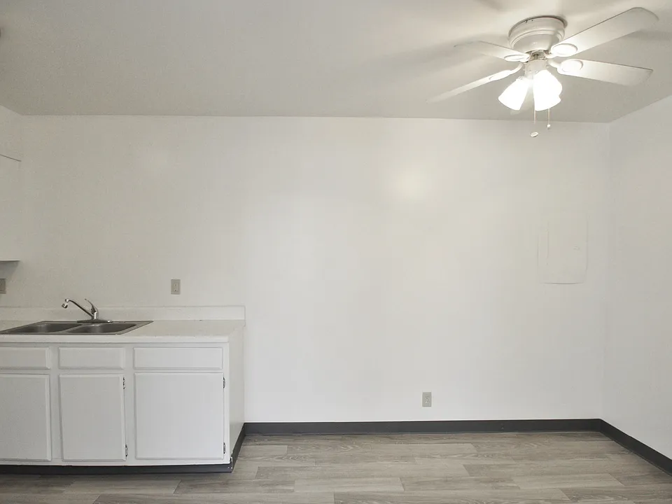 Dining area with overhead lighting and hardwood-style flooring