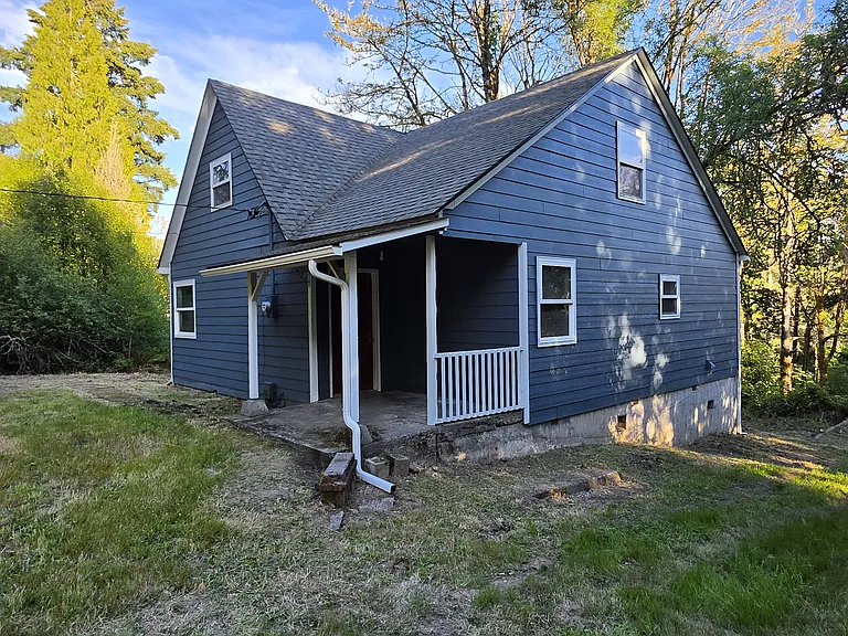 Front west side of house from driveway with covered entry